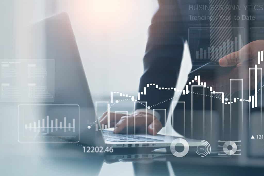 Business, finance and investment concept. Businessman using digital tablet analyzing financial data with economic graph growth chart, Business strategy and planning. market research